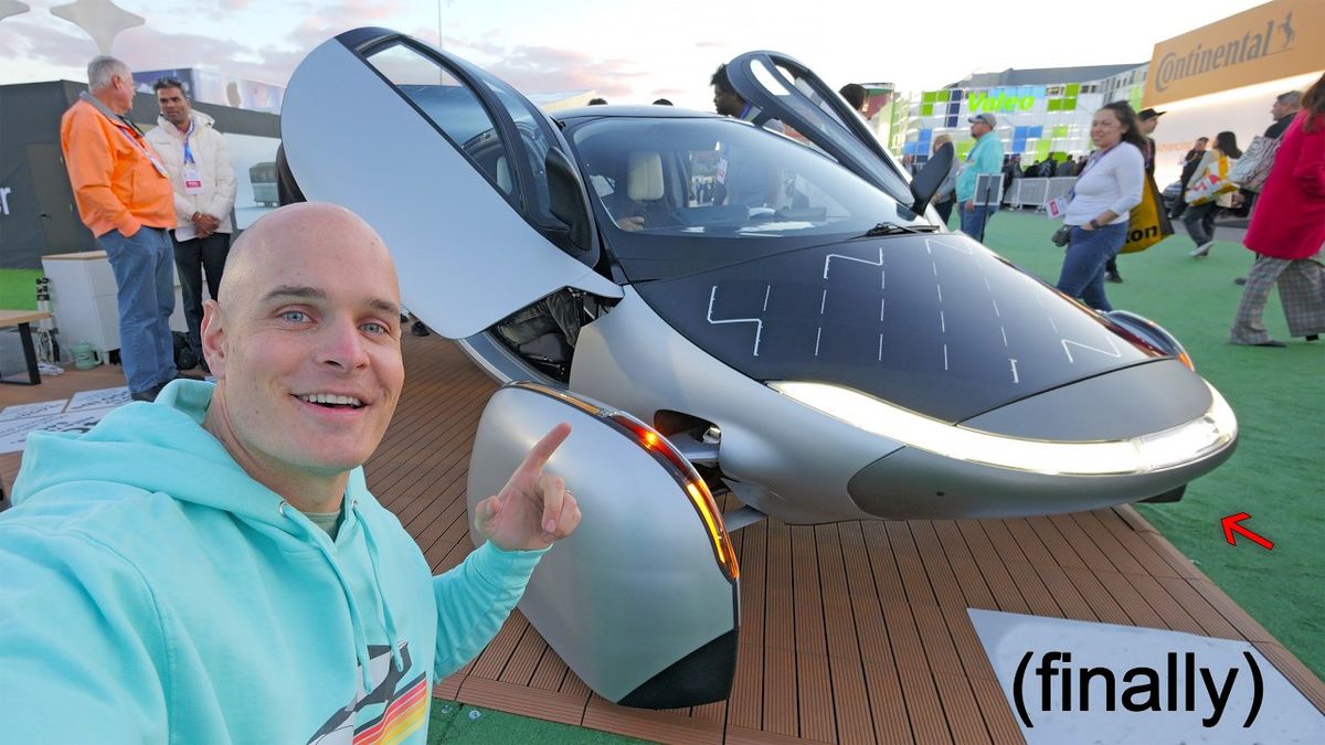 A thumbnail image for the video "The 3 Craziest Machines at CES 2025" from the channel JerryRigEverything. The image shows Jerry standing with a surprised expression next to a futuristic flying machine, with vibrant lights and a busy convention center background. Text overlay reads, "They wouldn't let me fly it!