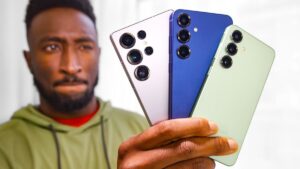 Thumbnail image for the video "Samsung Galaxy S25/Ultra Impressions: What Happened?" by Marques Brownlee, featuring Marques holding the Samsung Galaxy S25 Ultra with a puzzled expression, set against a blurred tech-themed background.