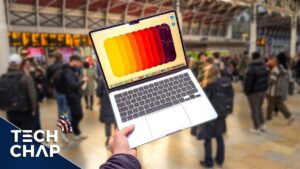Thumbnail image for the video "MacBook Air M4 - Real World Review (FINALLY Time to Upgrade?)" from The Tech Chap channel, featuring a sleek MacBook Air M4 on a wooden desk with a blurred background, highlighting its thin design and modern aesthetic.